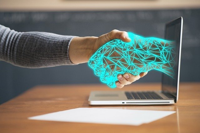 Digital hand going out of a laptop